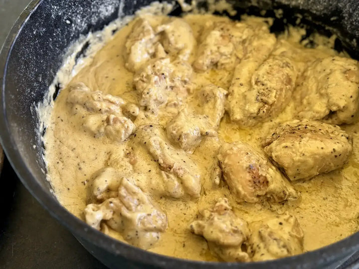 Chicken in creamy sauce, skillet.