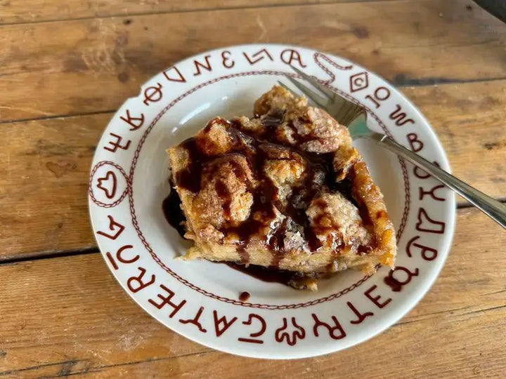 Here's an alt tag for the image: Delicious bread pudding with chocolate sauce.