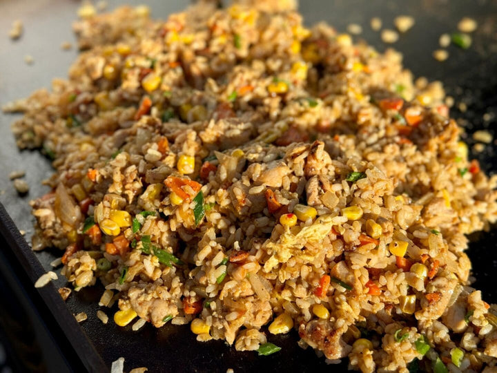 Delicious chicken fried rice on griddle.