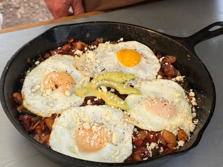 Four perfectly cooked over-easy eggs atop a delicious Mexican Hash in a 10" Mexican Skillet.